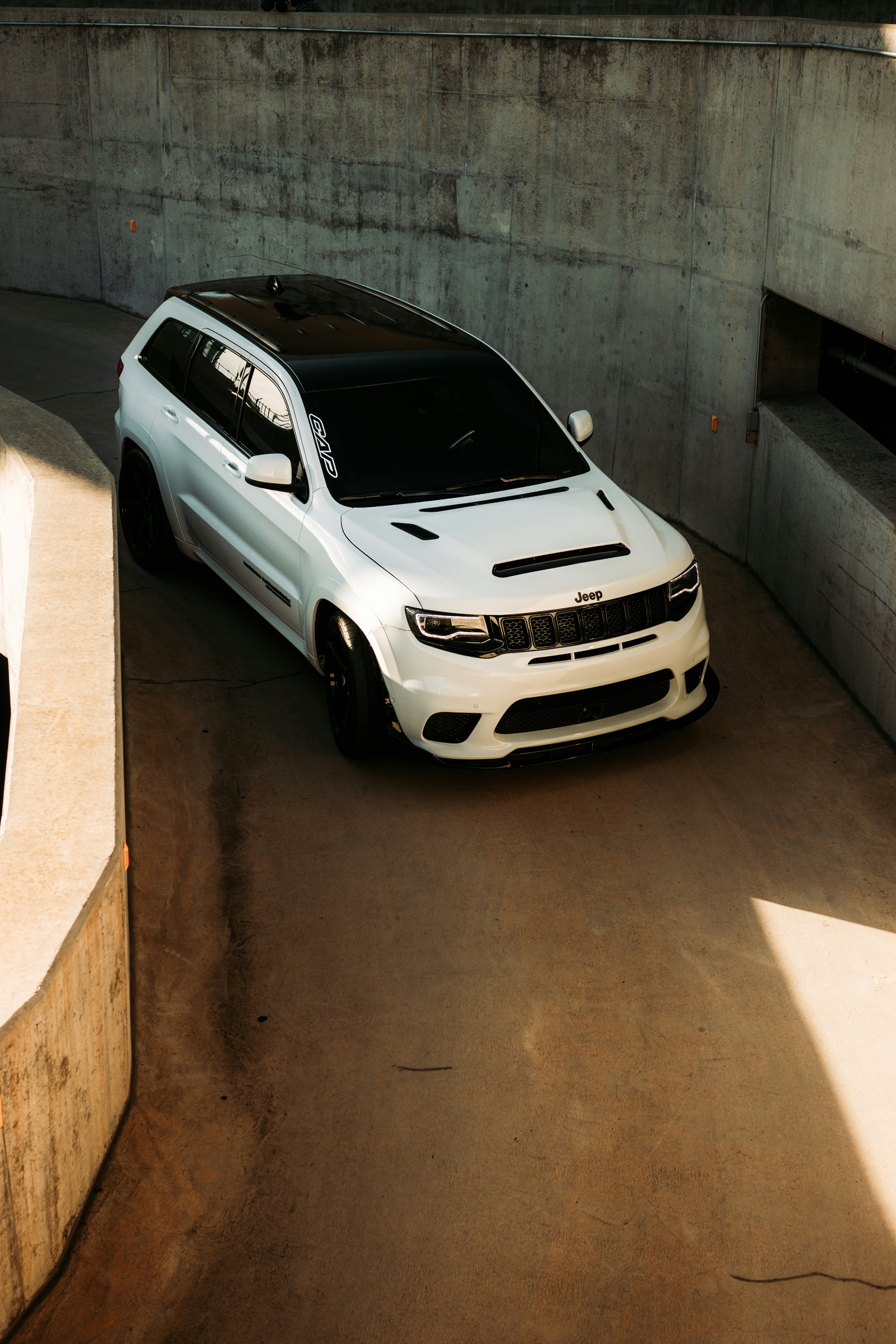 white bmw m 3 coupe parked on gray concrete pavement